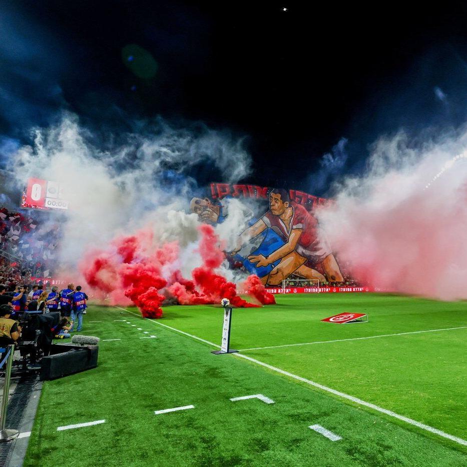 Israeli soccer game abandoned after rioting rival fans throw flares and smoke grenades